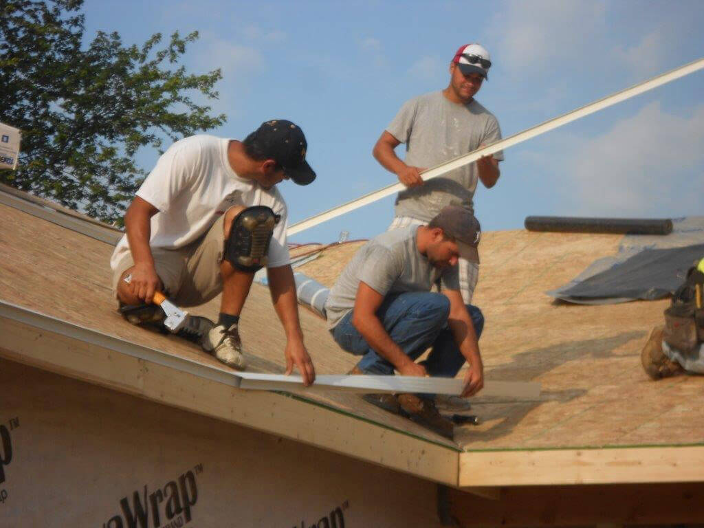 ROOF Management CO community project guys on a residential roof zoomed in